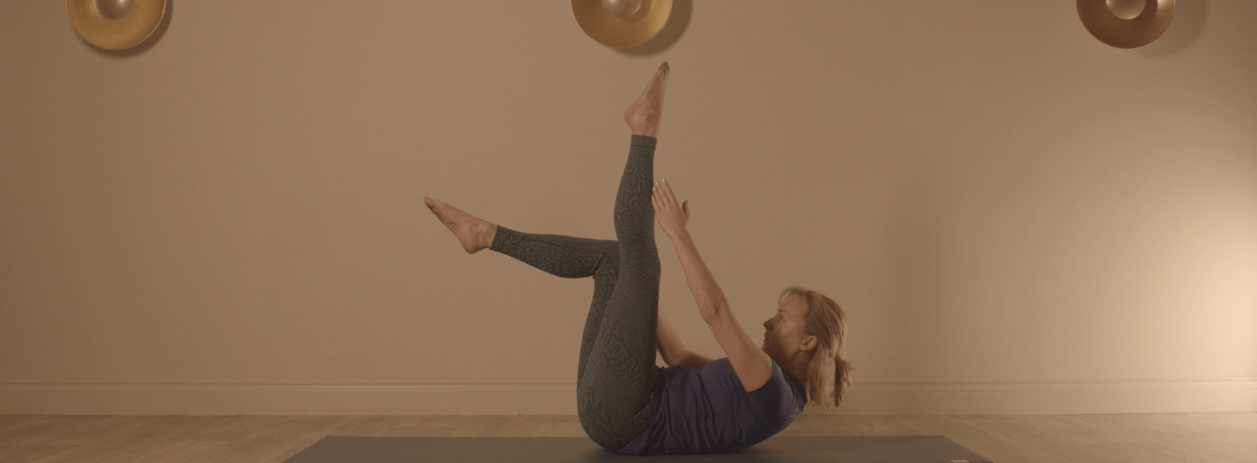 Instructor performing our hernia rehabilitation exercises on a mat on the floor.